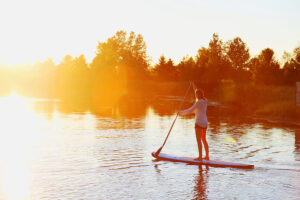 Photo of a woman paddle boarding