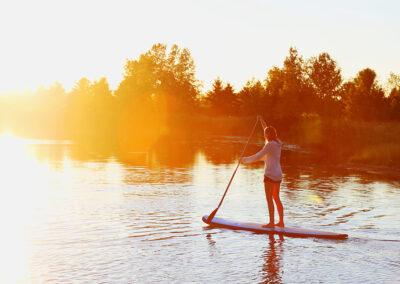 Photo of a woman paddle boarding